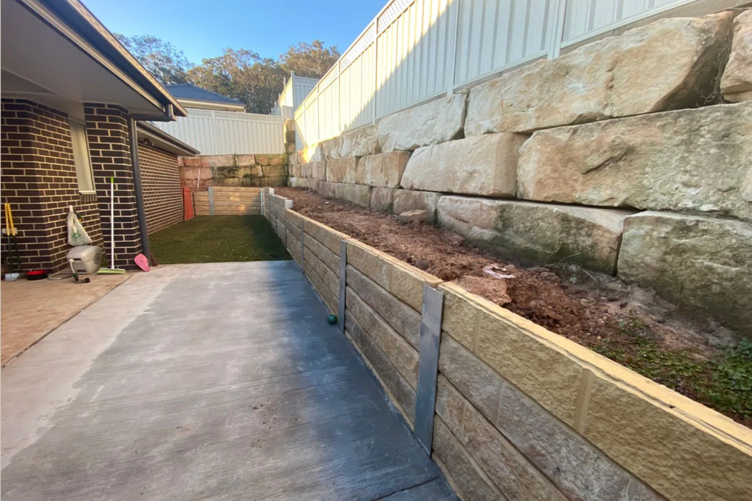 Sandstone-tone concrete sleeper retaining wall with bamboo garden bed